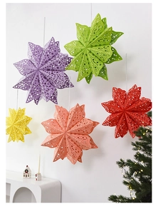 Close-up of laser-cut paper star lanterns in five colors for Christmas wall decor