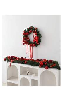 Close-up of festive Christmas wreath and garland set with red velvet bows and pine needles