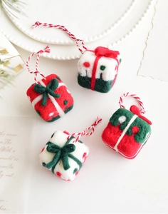 Detailed close-up of wool felt mini gift box ornaments for festive Christmas tree decor
