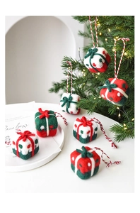Detailed close-up of wool felt Christmas gift box ornaments hanging on a decorated tree