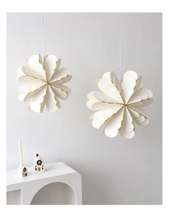 Close-up of multilayer white paper star ornaments with elegant gold edges for Christmas