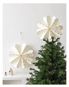 Detail of elegant cream layered paper star with gold edges as festive wall decoration