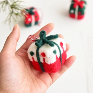 Mini handmade wool felt Christmas gift box ornament with green bow and festive hanging loop
