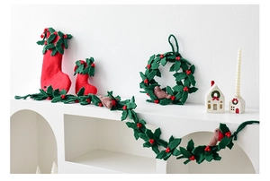 Detail of wool felt Christmas wreath with red robin bird and berries ornaments