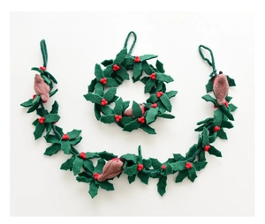 Detailed view of handmade wool felt holly wreath with red berries and robin bird ornament