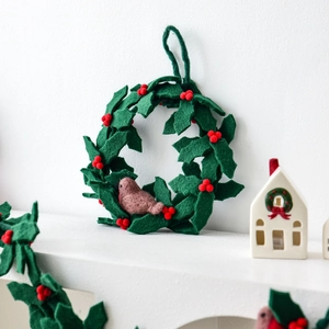 Handmade wool felt Christmas wreath with green leaves, red berries and a robin bird ornament