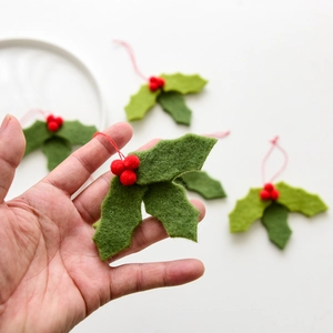Handmade wool felt holly leaf ornament with red berries and festive red hanging string
