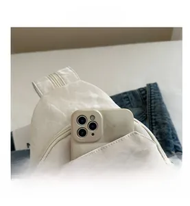 Close-up of marble texture sling bag showing spacious front pocket fitting a smartphone