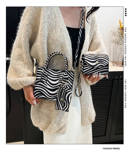 Chic zebra pattern handbag set including tote and chain crossbody bag shown on model