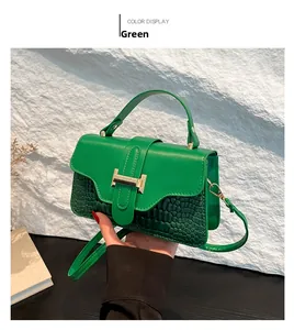 Detailed view of the green shoulder bag featuring premium crocodile texture and metal buckle