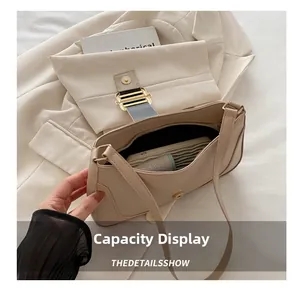 Internal capacity of the beige leather shoulder bag showing daily essentials and lining