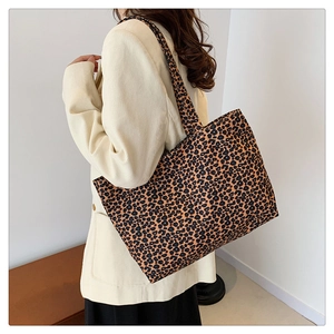 Macro detail of high-capacity leopard print tote bag with thick canvas fabric texture