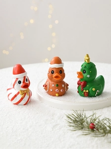 Close-up of creative Christmas resin ducks featuring gingerbread and Xmas tree designs