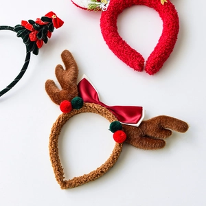 Christmas headbands with reindeer antlers, red bows and Merry Christmas festive decorations