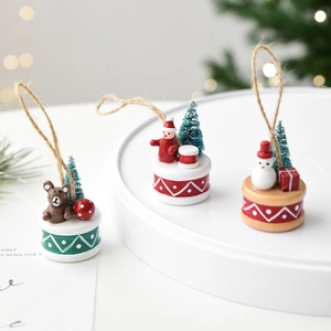 Miniature wooden Christmas ornaments with bear, Santa and snowman on a white display tray