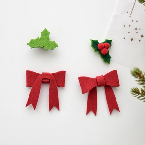Felt Christmas bow with green holly leaves and red berries for tree decoration