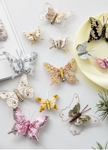 Detailed view of assorted glitter butterfly clips with mesh wings for holiday decorations