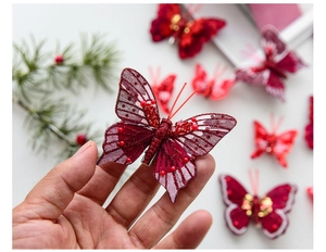 Detail of a red mesh butterfly ornament with sequins and beads for Christmas decor