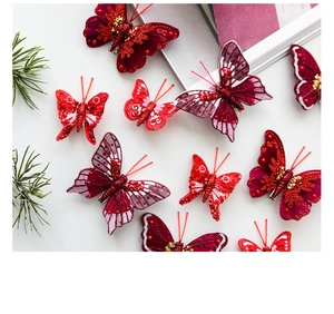 Detailed view of purple glitter butterfly ornaments in various sizes with sequins and clips