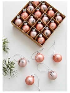 Top view of 16-piece rose gold Christmas balls with Merry & Bright and pine tree prints