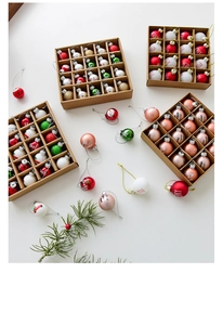 Detail of colorful hand-painted glass Christmas ornaments with festive Noel and Joy patterns
