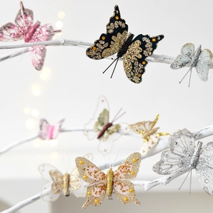 Sparkling butterfly ornaments for Christmas trees with glitter and bead details on branches
