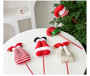 Close-up of plush Christmas elf leg picks and hats with sequins and bells for tree decor
