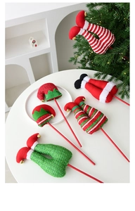 Detail of Christmas elf legs and hat picks with festive red and green sequins and bells