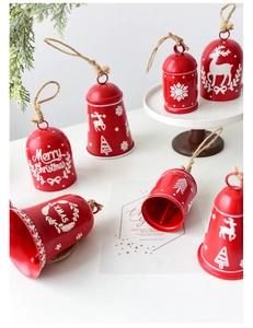 Detail of red Christmas bells with festive reindeer patterns and jute rope hangers
