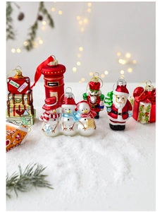 Detailed close-up of hand-painted glass Christmas ornaments on a snowy background
