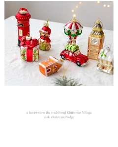 Detailed collection of assorted blown glass Christmas ornaments on a snowy background