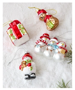 Detail of hand-painted glass Christmas ornaments including teddy bear and snowman set