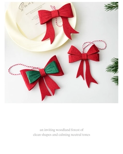 Detail of red and green felt Christmas bow ornaments with cotton hanging strings