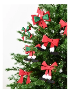 Detail of Christmas tree bows featuring Santa legs and classic red-green felt ornaments