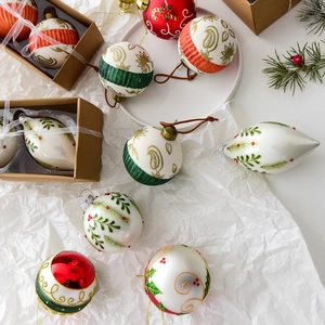 Set of luxury hand-painted glass Christmas ornaments in festive red, green, and gold colors