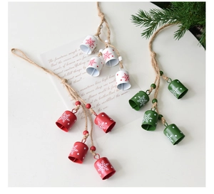 Detail of Christmas iron bells with snowflake patterns and wooden beads on twine