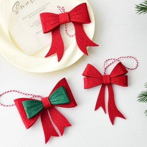 Three-piece handmade felt Christmas bows for tree decoration in festive red and green