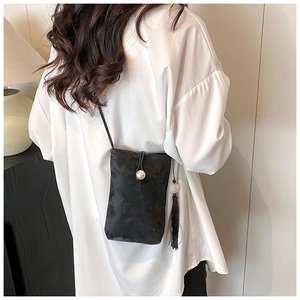 Chic black crossbody phone bag with large pearl clasp and long jade-style tassel detail