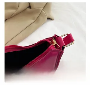 Detail shot of magenta PU leather handbag with gold metal zipper and D-ring closure
