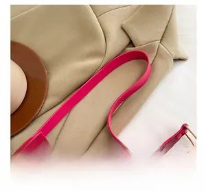 Close-up of rose red PU shoulder bag featuring golden metal hardware and premium zipper detail