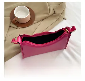Top view of spacious rose pink leather shoulder bag interior with sleek black lining