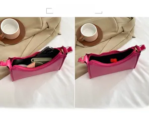 Detailed interior of the rose pink hobo bag showing capacity for phone and wallet