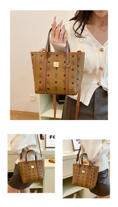 Détail du sac cabas marron à motif d'ours montrant les anses et la plaque dorée