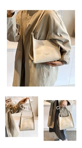 Detail of beige textured leather handbag with Fashion & Bags logo and shoulder strap