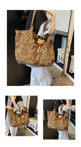 Detail of large leopard print canvas tote bag featuring a cute plush bear charm accessory