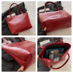 Detail view of burgundy tote bag with bone rib texture showing large storage capacity