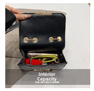 Detail shot of the interior capacity showing a phone, lipstick and sunglasses inside
