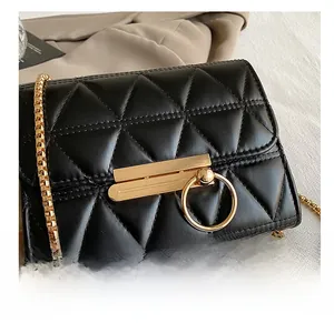 Detail view of premium gold hardware and quilted black leather on a chic mini bag