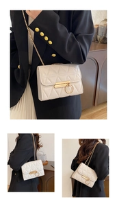 Detail view of cream quilted crossbody bag with golden chain strap and metallic ring buckle