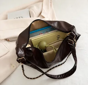 Deep coffee tote bag showing spacious interior with books and umbrella detail